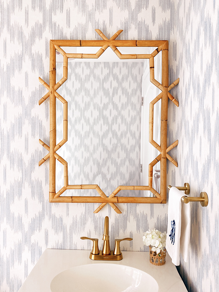 keller ogee blue ikat wallpaper, scalloped light, hermes scarf frame, serena and lily lanai mirror, bamboo mirror, blue and white powder room, bathroom renovation, monogrammed hand towel, amanda lindroth design woven hurricane glass